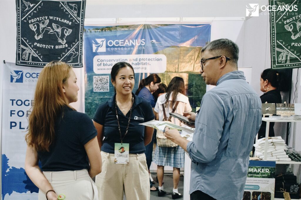 Sharing ideas and stories with visitors at the booth during the asian bird fair